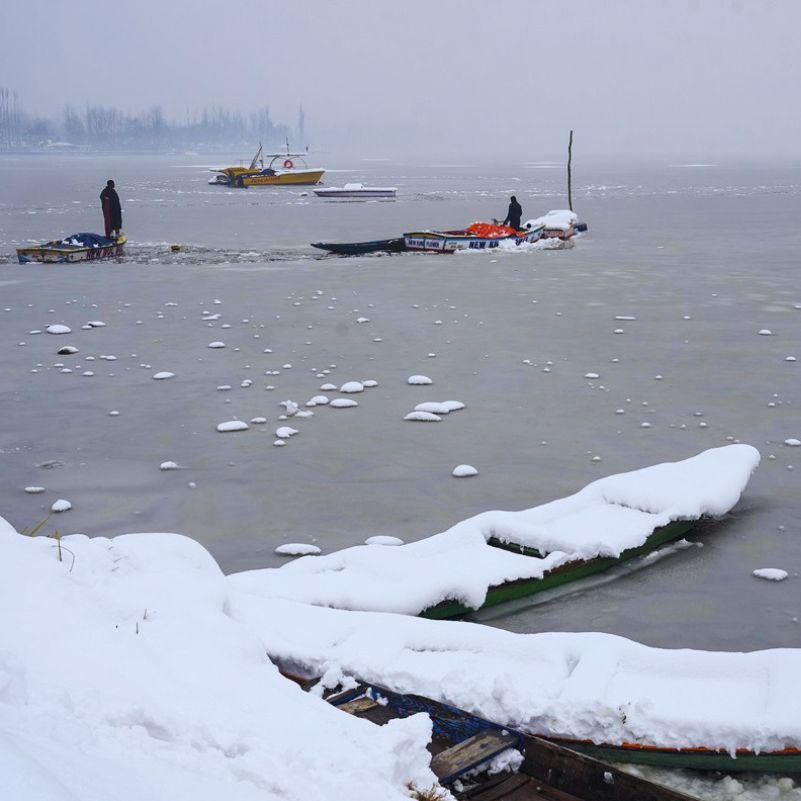 Traditional Kashmiri houseboats on Dal Lake during the winter season.jpg