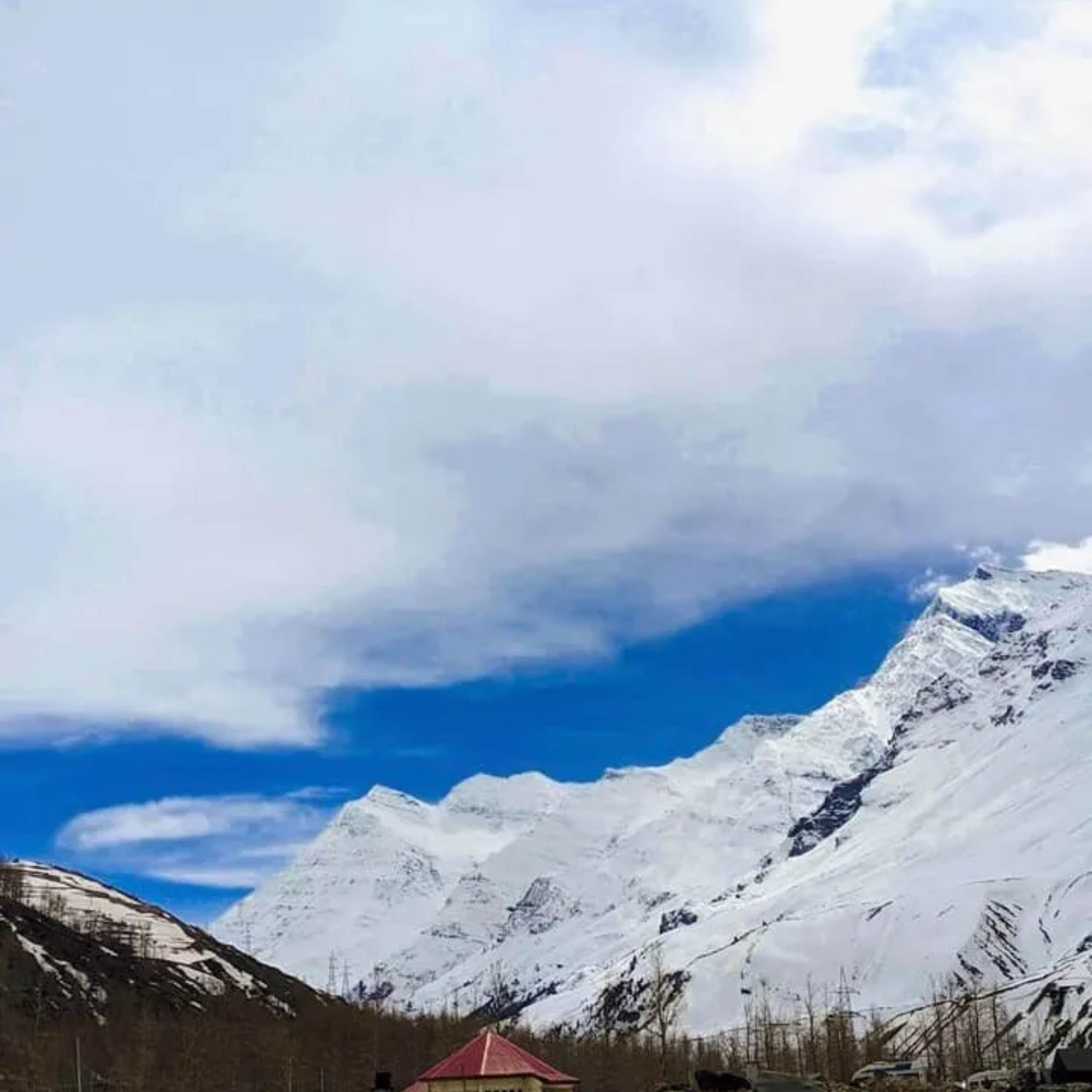 Sissu Village surrounded by snow-capped Himalayan mountains.jpg