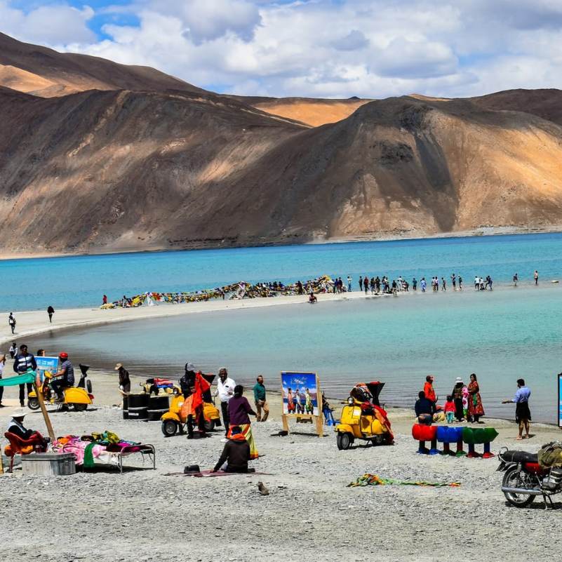 Turquoise shallows of Pangong Lake fading into deep blue further out, a colour shift that changes through the day
