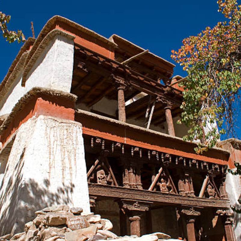 Traditional Buddhist architecture at Alchi with carved wooden lintels and prayer wheels