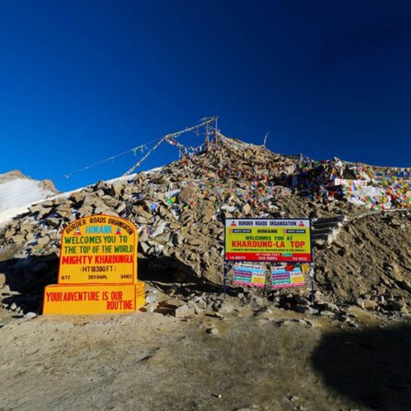 Travellers gathered around the altitude signboard at the top of Khardung La pass at around 5,359 metres, the common summer scene