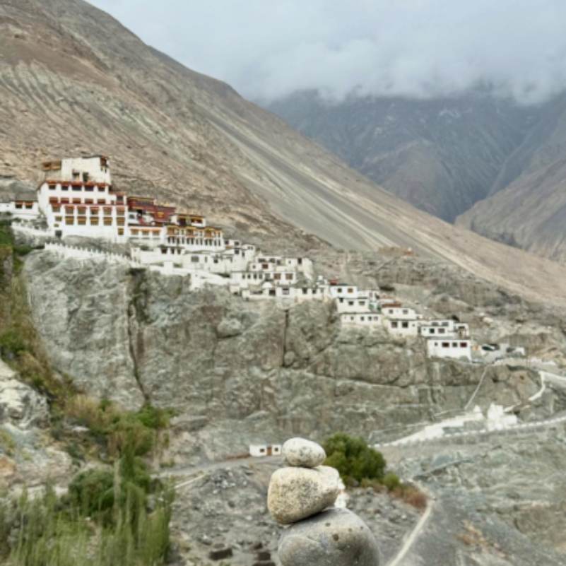 Whitewashed terraces and prayer halls of Diskit Monastery stacked up the hillside in classic Tibetan Gelugpa style