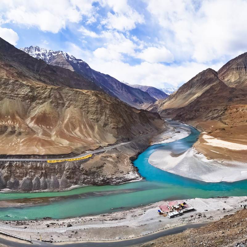 Indus and Zanskar rivers meeting at Sangam Point with barren Ladakh mountains behind