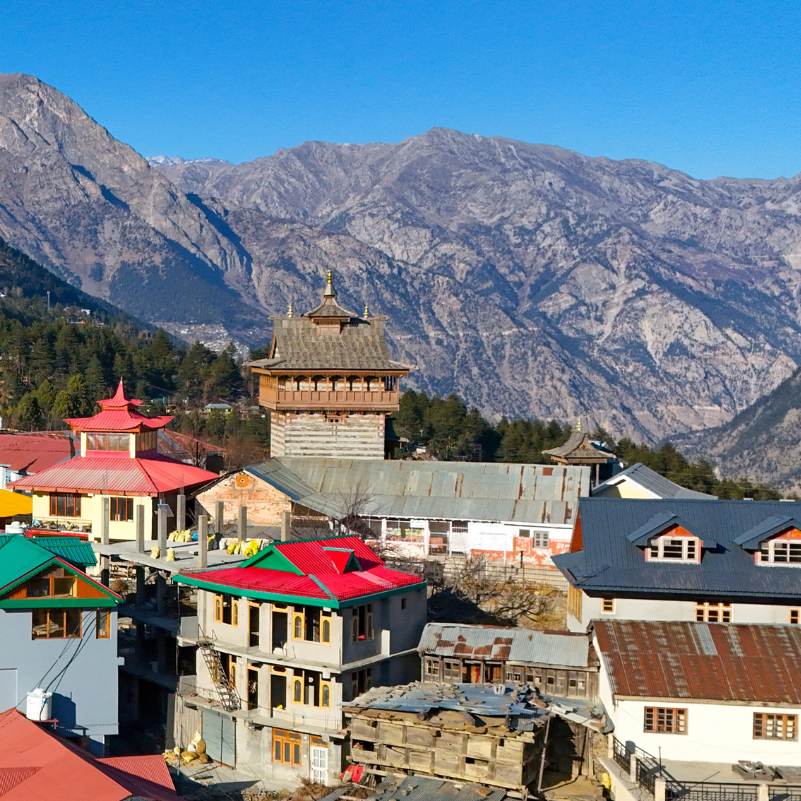 Sunrise light hitting snow peaks above Kalpa village