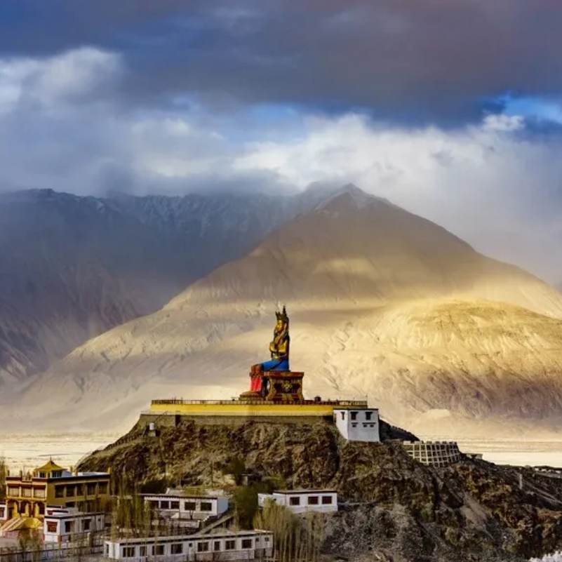 Diskit Monastery on its hilltop above Diskit village, the oldest Gelugpa gompa in Nubra Valley with whitewashed walls and prayer flags