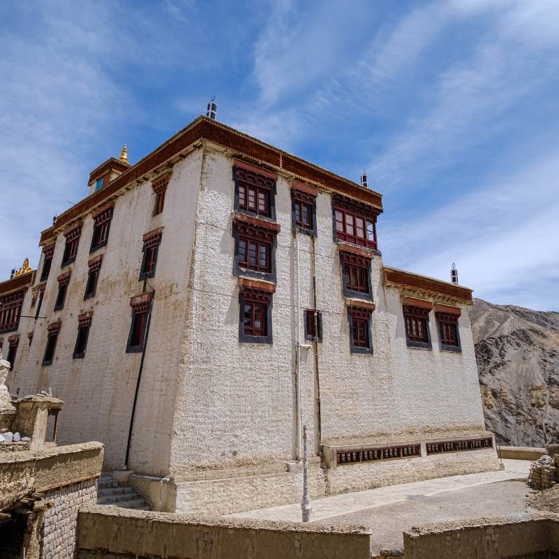 Whitewashed walls of Lamayuru Monastery against a deep blue Ladakh sky